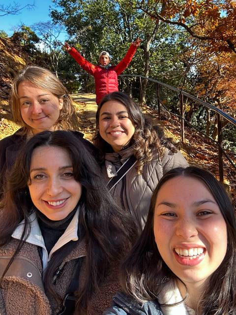 Close-up of four friends taking a selfie during a hike.