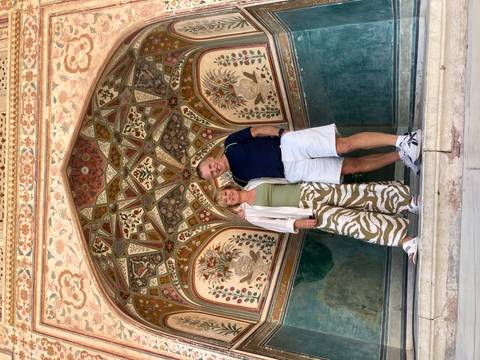 Two people under an intricately decorated archway.