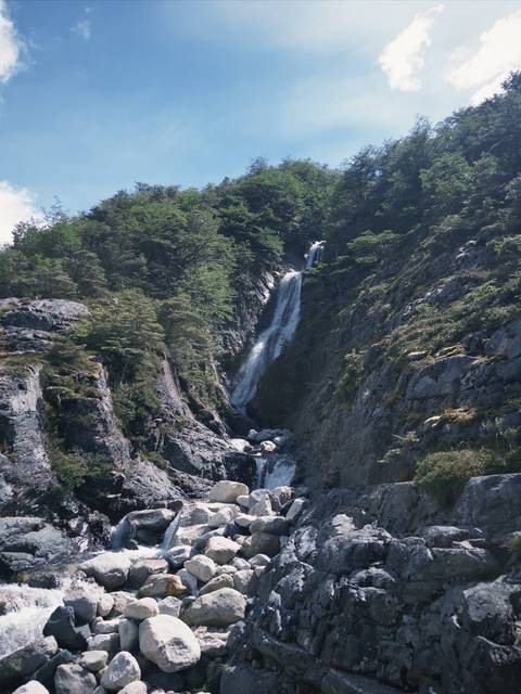       A waterfall cascading down a rocky cliff.
  