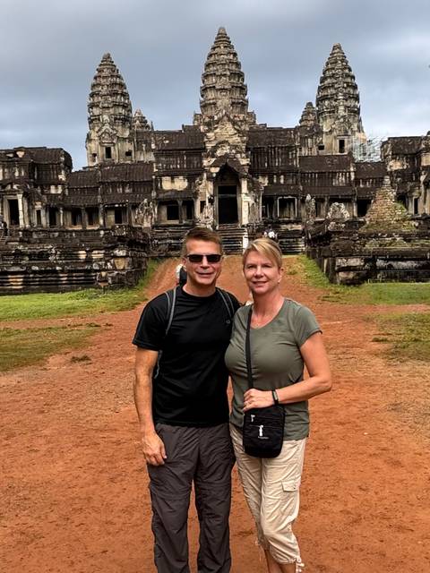 Couple standing in front of a historic temple.