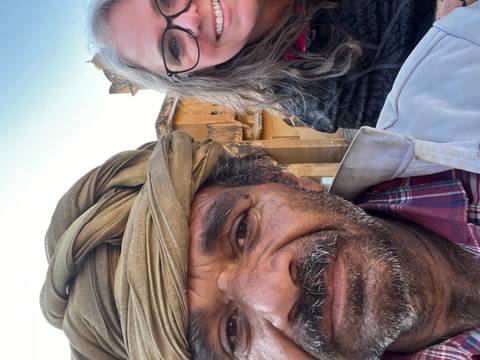 Close-up of a person wearing a turban next to another blurred person.