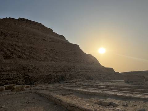 Step pyramid in the desert during a sunset.