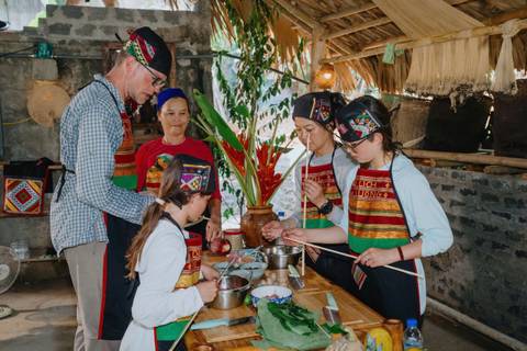       Group of people participating in a cooking class, preparing food.
  
