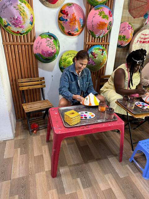       People participating in an art activity indoors.
  