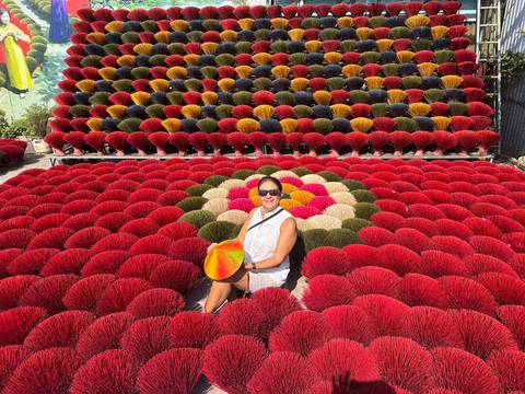       Woman surrounded by colorful incense sticks.
  