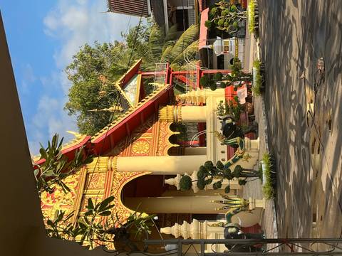       Buddhist temple with intricate decorations and garden.
  