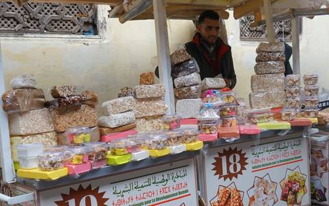       Street vendor selling Moroccan sweets.
  
