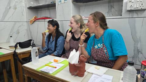 Women eating snacks in a brightly lit room.