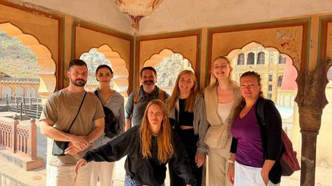 Group of tourists in a historic Indian palace.