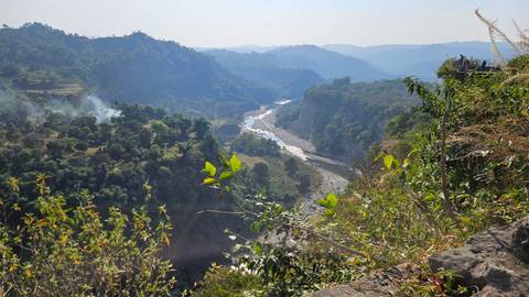 River cutting through a hilly landscape with dense forests.