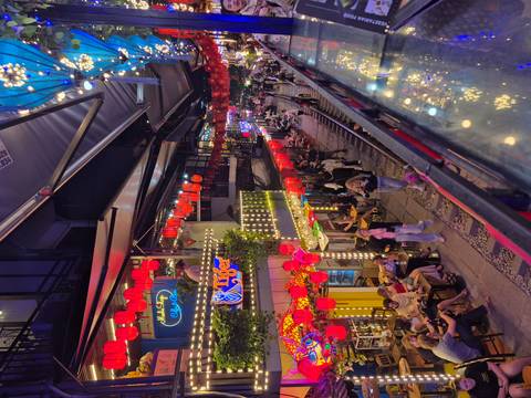 A vibrant street in Hanoi with lit decorations at night.