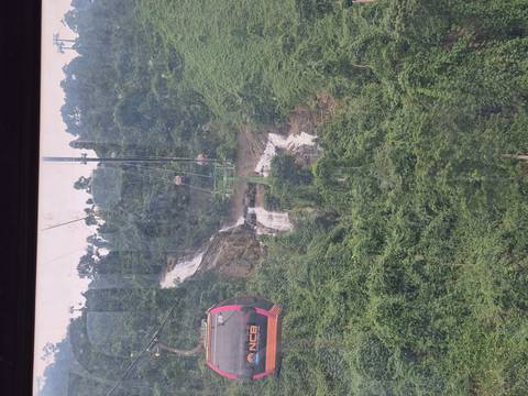 Cable car overlooking waterfalls and lush green forests.