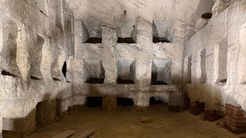       Ancient catacombs with stone niches.
  