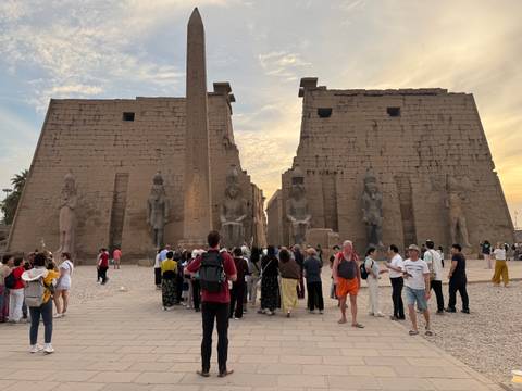       Crowd of tourists at the entrance of an ancient temple.
  