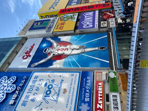 Iconic Glico sign in a busy street in Osaka.