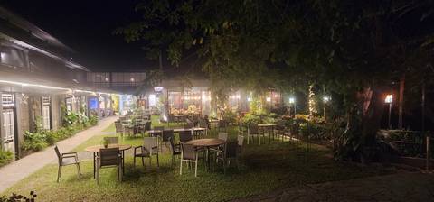 Night view of an outdoor dining area with tables and lights