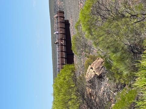 Wooden walkway over rocky landscape.