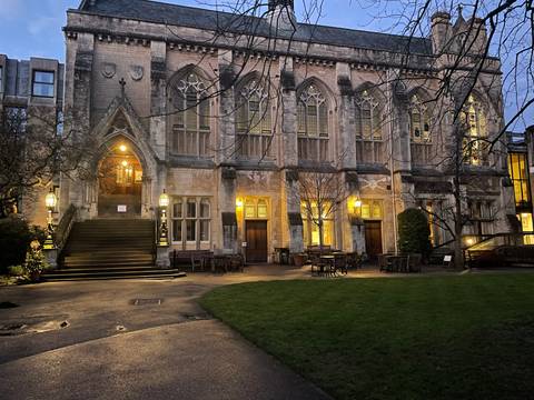       Historic building illuminated at night with gothic architecture.
  