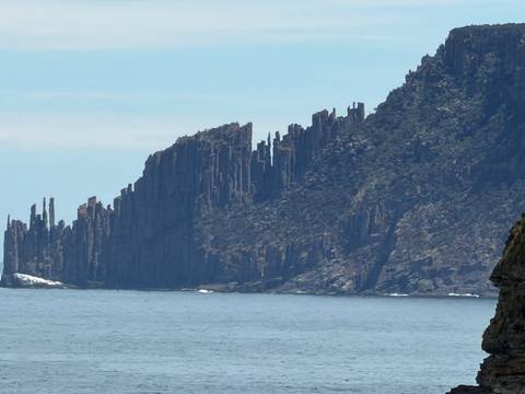       Dramatic cliffs with steep formations along the coast.
  