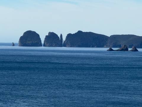 Islets visible across the ocean from the shore.