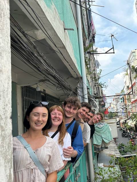 Group of people standing in an alleyway.