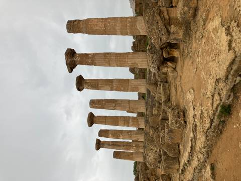 Row of ancient columns against a cloudy sky.
