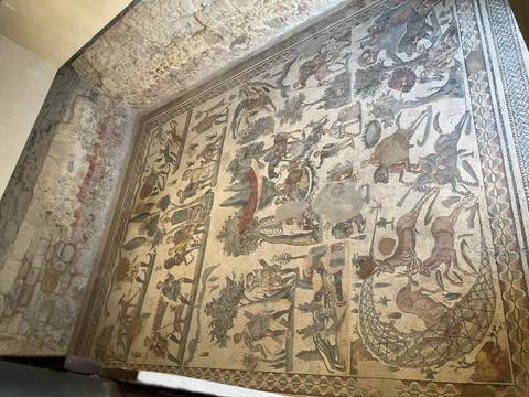 Large mosaic depicting various animals and people in a natural setting.