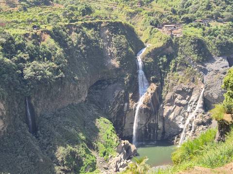 Scenic waterfall in a lush green valley.
