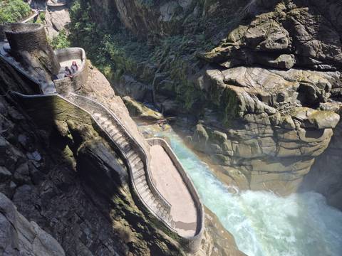 Rocky waterfall with people exploring.