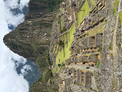       Aerial view of Machu Picchu showcasing landscape and ruins.
  