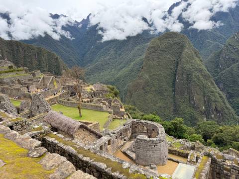 Panoramic view of Machu Picchu ruins with mountain background.
