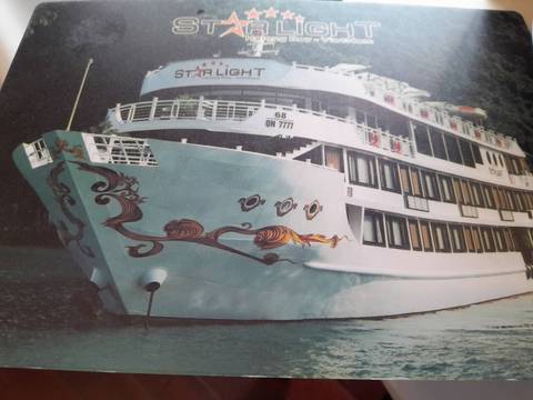 Cruise ship with decorative art on the waters of a bay.