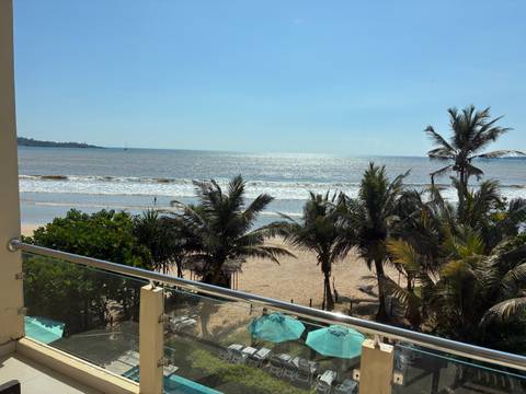 Beach view with palm trees and ocean.