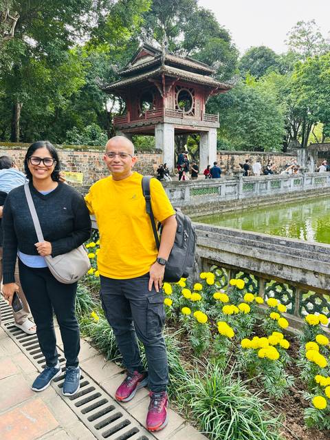       Visitors exploring a historical site by the water.
  
