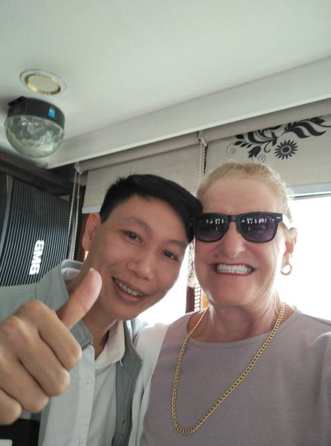       Two people smiling for a photo on a boat.
  
