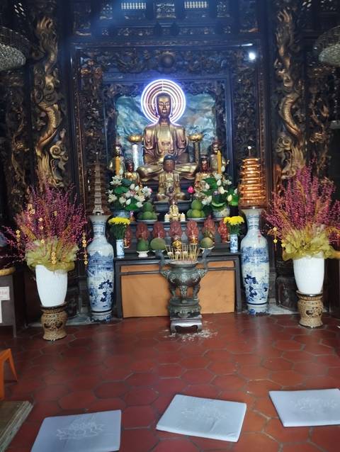       Altar with offerings and ornate decorations.
  