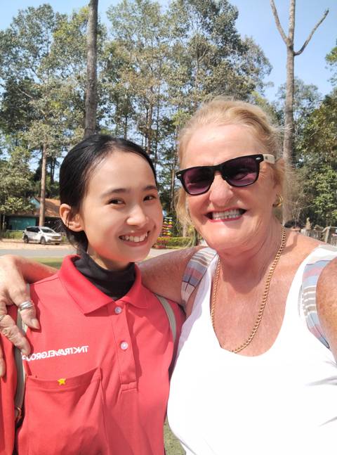       Two people smiling in a park.
  