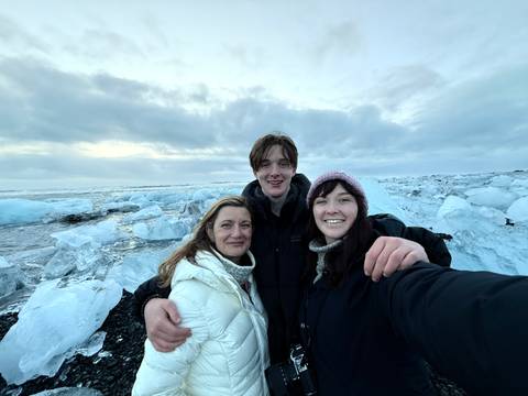 Group of people with icebergs in the background.