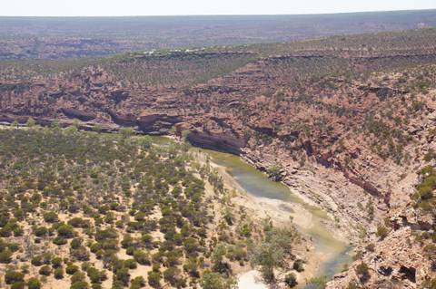A river winding through a rocky canyon landscape.