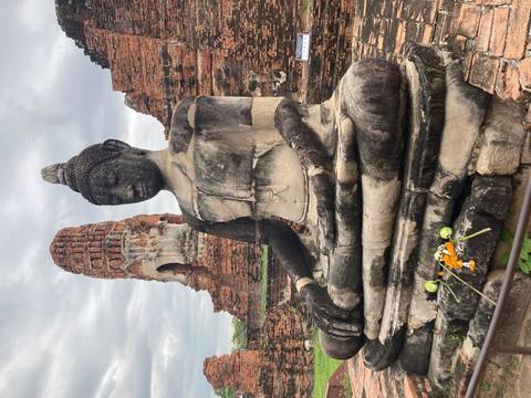 Statue of Buddha among ancient brick structures.
