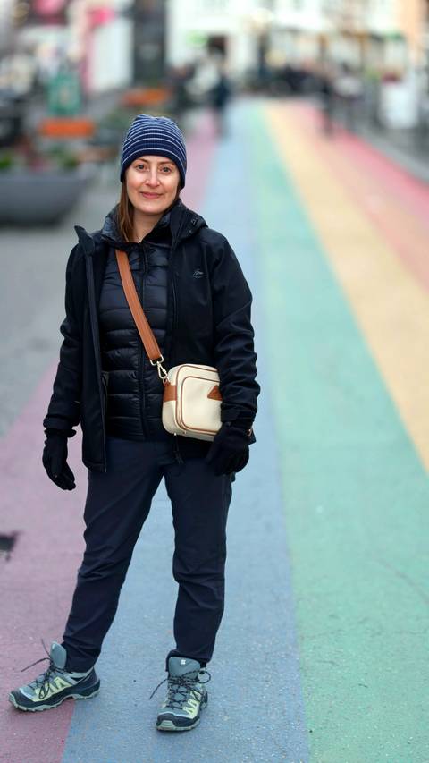Person standing on a colorful striped pavement.