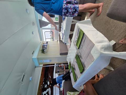       Dining area on a boat with tables set for a meal.
  