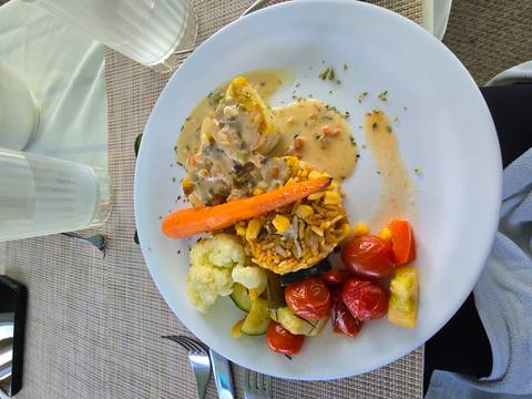       Plated meal with vegetables and sauce.
  