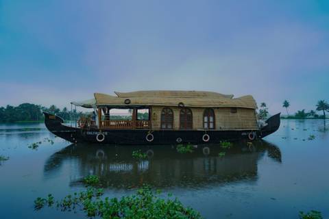 Traditional houseboat on a tranquil lake in the early morning.