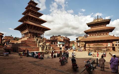 A busy public square with Nyatapola Temple and other historic buildings in Bhaktapur.