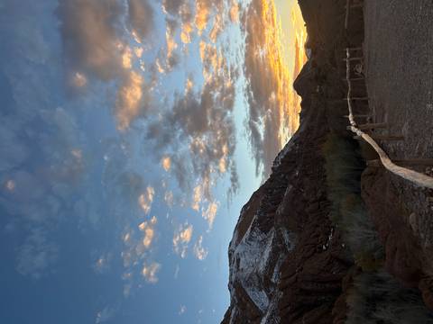       Scenic landscape of mountains and clouds at sunset.
  