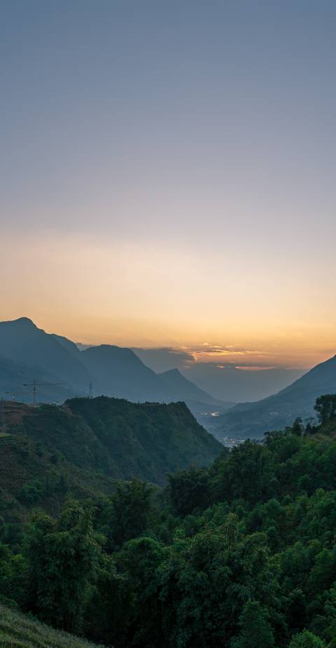       Scenic view of mountains during sunset with a serene atmosphere.
  