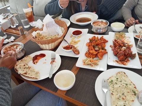 Table with various traditional dishes being served.