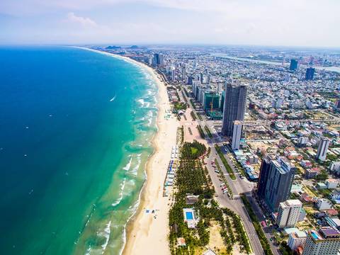 Aerial view of Da Nang city along the coastline with tall buildings.