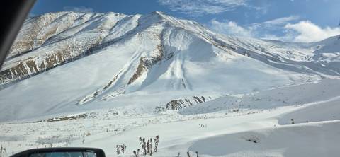 Snow-covered landscape with mountains.